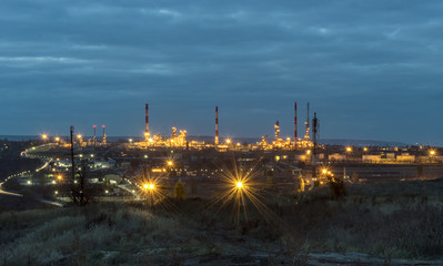Oil refinery in the evening, under artificial lighting