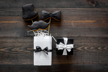 Black tie, mustache and hat cookies on sticks for happy father's day present cookies wooden background top view space for text