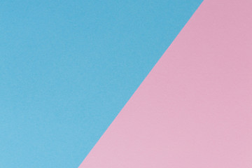 Soft pink and light blue pastel colored paper background.
