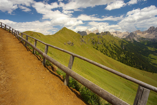 Mountain way with a woody balustrade, Dolomites, Italy