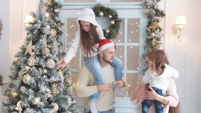 Family decorating a Christmas tree