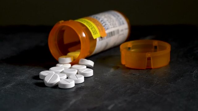 Macro video of Oxycodone Opioid tablets on slate table