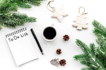 Make to do list for new year. Notebook among new year decorations on white background top view