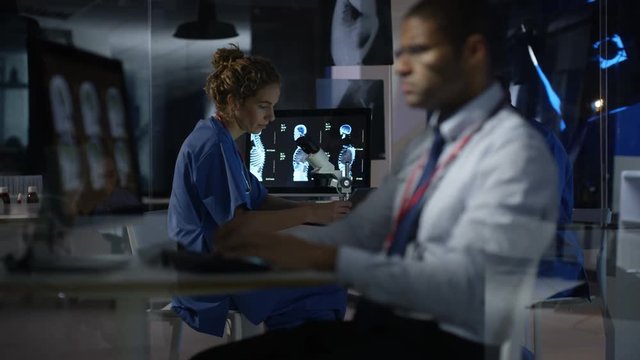  Medical team using computers, working night shift in hospital