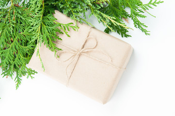 Fototapeta na wymiar presents wrapped in brown paper on a white background with greenery