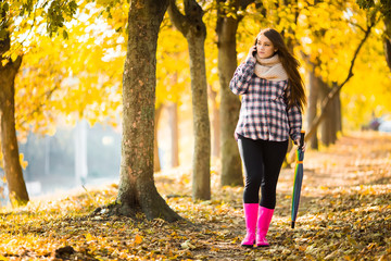 Pregnant woman walking in autumn park