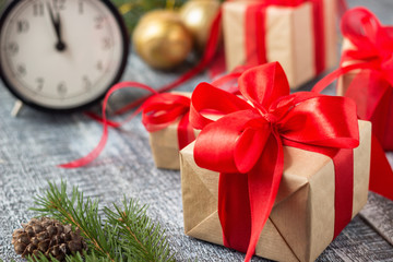Christmas decorations. Present boxes and christmas balls near alarm clock.