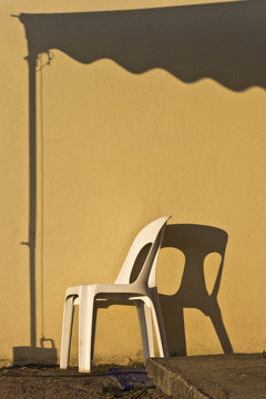 Lonely chair under a canopy of shade