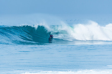 Bodyboarder surfing ocean wave