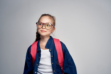 girl in glasses looks into the distance