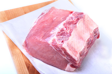 Raw pork chops with herbs and spices on cutting board. Ready for cooking.