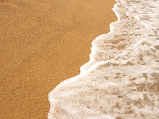 Foamy shoreline in Costa Brava beach at summer
