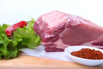 Raw pork chops with herbs and spices on cutting board. Ready for cooking.