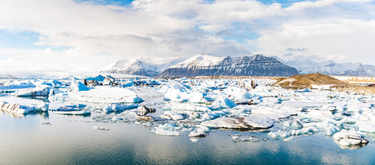 jokulsarlon glacier lagoon with iceberg floating and mountains on background © william87