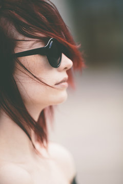 young woman with retro sunglasses ,windy day .