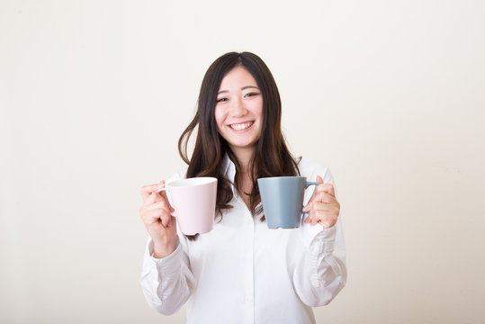 young asian woman giving mug cup
