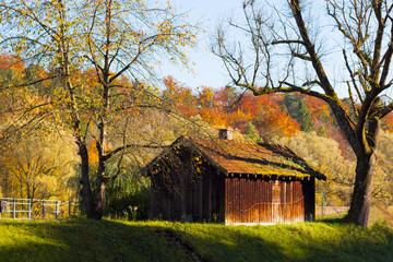 The scenic landscape. house by river. Reflection in water. Forest and mountains surround the house. autumn. CLosedup