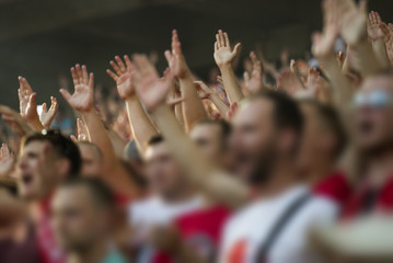 Football fans clapping on the podium of the stadium