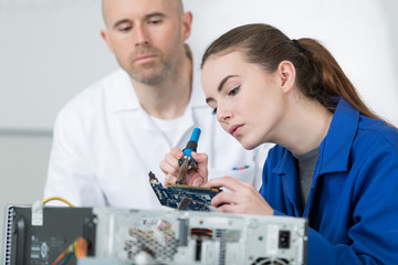 female repairing part of computer components