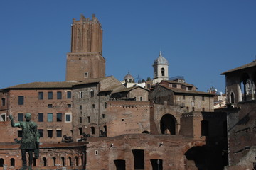 Cityscape of Rome, Italy with statue of roman emperor.