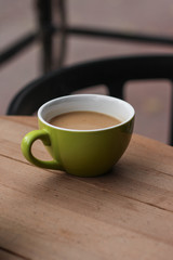 cup of hot drink coffee with milk in the open air