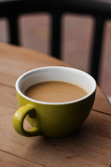 cup of hot drink coffee with milk in the open air