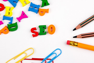 SEO Search Engine Optimization. Colored wooden letters on a white background.