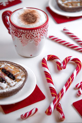 Cup of coffee with heart shape christmas candy and cake on the white  background.