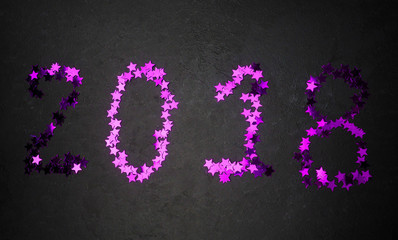 2018 figures on a black background purple sequins, the concept of the new year