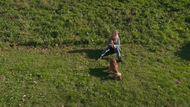 Young girl with cocker spaniel outdoors