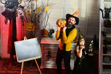 Girl and bearded man with smiling faces near blackboard