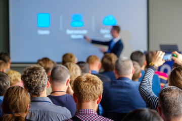 Audience listens to the lecturer at the conference hall