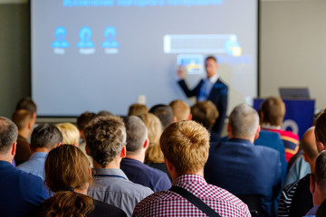 Audience listens to the lecturer at the conference hall