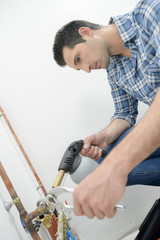 Plumber using a blow torch