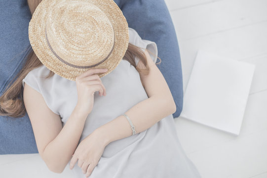 Lovely girl lying on a shofa in white room.