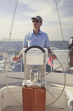 Young man sailing in the pacific ocean