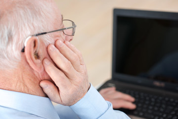 Elderly man using laptop