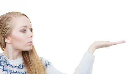 Teenage blonde woman pointing at copyspace