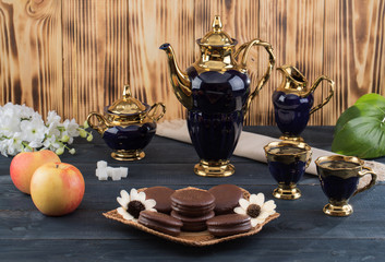 coffee on the table with background with cakes and apples