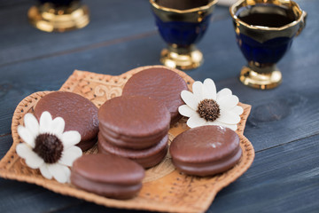 coffee on the table with background with cakes and apples