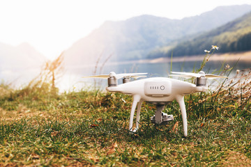 White drone on the meadow near Lake Vidraru at Fagaras Mountains. Romania