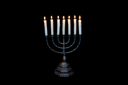 Ancient ritual candle menorah on a black background