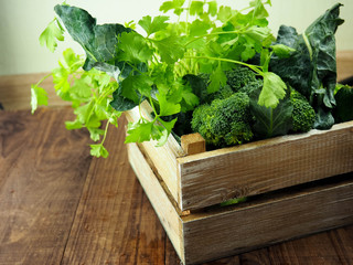 Fresh green vegetables ,diet or healthy food concept , in a crate on the table