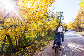 Young active sport girl with bicycle outdoor
