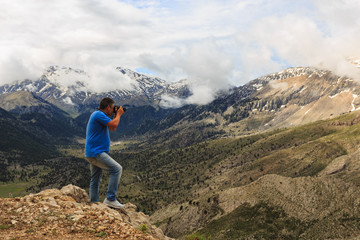 Landscape photographer in mountains