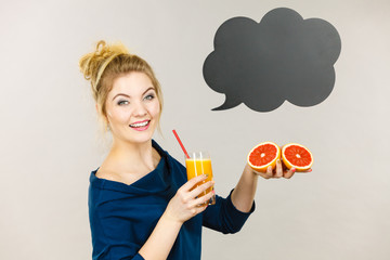 Happy woman holding fresh orange juice