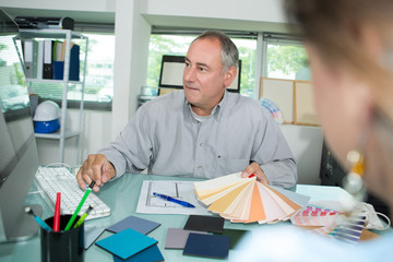 man choosing color swatches