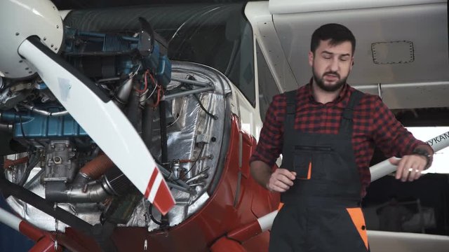 The mechanic tells the principle of the aircraft engine for repair.