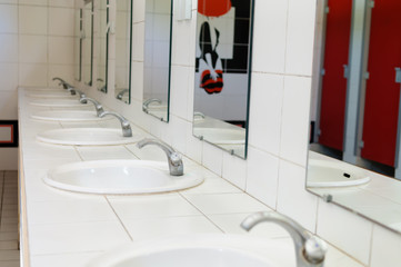 Sinks in a gents toilet block.