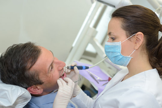 Female dentist working on patient's teeth